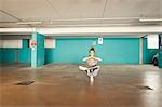 Woman practising yoga in parking lot