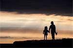 Brother and sister, walking hand in hand, at sunset, Doolin, Clare, Ireland