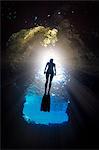 Woman free-diving, low angle view, Swallow Cave, Vavau, Tonga, Fiji