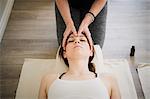 Woman enjoying head massage in yoga retreat