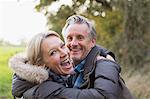 Portrait happy mature couple hugging in park