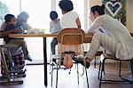 Young family in pajamas coloring at dining table