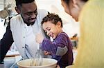 Happy father and son baking in kitchen