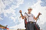 Mature male paraglider preparing equipment