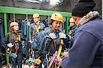 Friends preparing zip line equipment