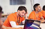 Focused hacker coding for charity at hackathon