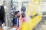 Smiling businessman meeting with colleagues in office