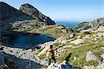 Hiking next to the clear water of Elenino Lake near Maliovitsa in the Rila Mountains, Bulgaria, Europe