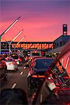 Traffic going into Los Angeles airport under a vibrant orange and pink sunset, California, United States of America, North America