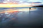 A woman walks on Southerndown beach, Ogmore, South Wales, United Kingdom, Europe