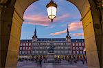 View of Casa de la Panaderia in Plaza Mayor through archway at dusk, Madrid, Spain, Europe