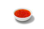 Chilli sauce in a gravy boat. White background