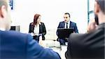 Business people sitting at working meeting in modern corporate office. Business and entrepreneurship concept.