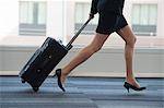 Businesswoman running through the lobby of conference centre.