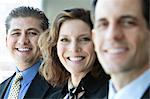 A closeup portrait of a row of multi ethnic business people, with focus on the Hispanic businessman.