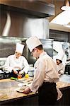A crew of chef's working in a commercial kitchen,
