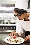 A black female chef working in a commercial kitchen,