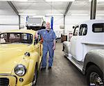 Portrait of a senior Caucasian male owner of an antique car repair shop