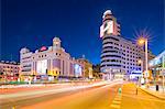 View of architecture and trail lights on Gran Via and Plaza del Calao at dusk, Madrid, Spain, Europe