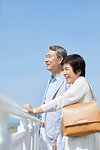 Japanese senior couple having fun by the sea