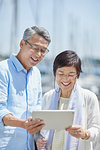 Japanese senior couple having fun by the sea