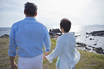 Japanese senior couple having fun by the sea