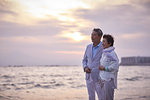 Japanese senior couple having fun by the sea