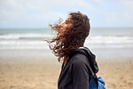Female tourist with flyaway hair on beach, Las Palmas, Gran Canaria, Canary Islands, Spain