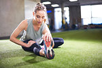 Woman doing stretching exercise in gym