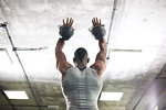 Man lifting kettlebells in gym