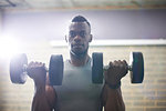 Man lifting dumbbells in gym