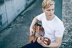 Young musician playing guitar