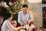 Family enjoying candlelight Christmas dinner