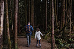 Father and daughter hiking in forest, Tofino, Canada