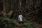 Girl hiking in forest, Tofino, Canada