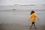 Girl playing on beach, Tofino, Canada