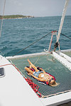 Young woman relaxing on sailing boat, British Virgin Islands