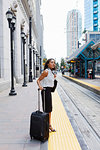 Businesswoman waiting on light rail platform