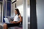 Businesswoman using laptop on train