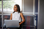 Businesswoman using laptop on train