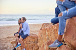 Friends relaxing on beach, Plettenberg Bay, Western Cape, South Africa