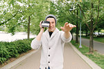 Young man taking photo with instant camera, Vancouver, Canada
