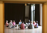 Active seniors meditating in circle