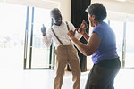 Playful, active senior couple dancing