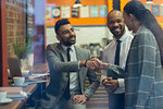 Business people handshaking in cafe