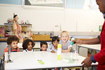 Curious kids watching science experiment in science center