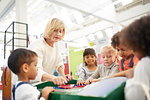 Teacher and students at interactive exhibit in science center