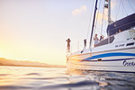 Friends on catamaran at sunset