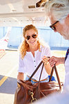 Couple with bag on airport tarmac