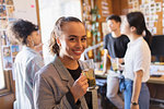 Portrait confident businesswoman drinking tea